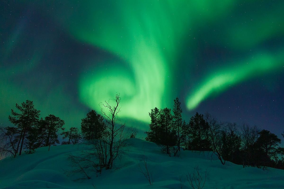 Northern lights band swirls above Vuopajanniemi, Inari, Lapland, Finland, 2018 March